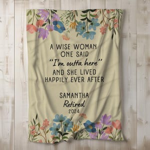 May include: A beige throw blanket with a floral design and the text "A wise woman one said "I'm outta here" and she lived happily ever after" with the name Samantha and the year 2024.