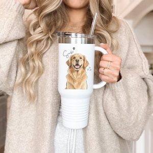 May include: White insulated tumbler with a handle and a silver lid. The tumbler features a watercolor illustration of a golden retriever, the name "Suzi" in script, and paw prints and hearts.