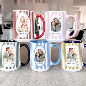 May include: Six white ceramic mugs with personalized portraits and names. Each mug features a different couple, with vertical striped patterns in red, pink, green, blue, and gold. The mugs have colored handles and rims.