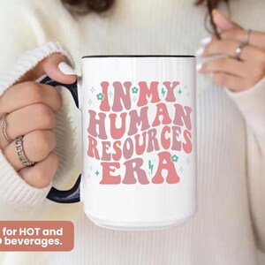 May include: White ceramic mug with a pink and blue design that says "In My Human Resources Era".