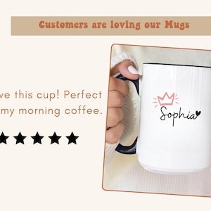 May include: White ceramic mug with a black rim and handle. The mug features a pink crown and the name "Sophia" written in black cursive.