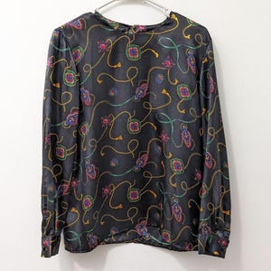Vintage 80s black geometric blouse long sleeve lightweight polyester blend women’s large boxy fit retro statement top