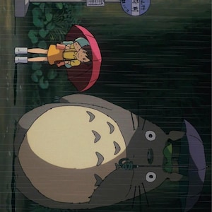 May include: An animated scene from a rainy day. Two children under a red umbrella stand near a bus stop. A large, gray, furry creature with a leaf on its head holds a purple umbrella.