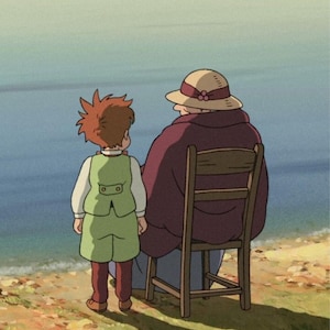 May include: An animated scene depicts a child and an older person by the sea. The child, in a green vest and shorts, stands facing the water. The older person, wearing a hat and a maroon shawl, sits on a wooden chair. The scene is set on a grassy shore.