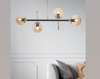 Lampadario nero e oro con altezza regolabile e globi in vetro ambrato, lampada a sospensione a soffitto lineare contemporanea