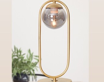 Golden Table Lamp with Smoked Glass Globe, Modern Metal Desk Light, Elegant Gold-Framed Bedside Lighting Piece Contemporary Home Decor