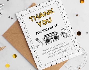 May include: A white thank you card with a brown envelope. The card has a yellow and black design with the words "THANK YOU FOR KICKIN' IT!" and a boombox illustration. Musical notes and stars decorate the card.