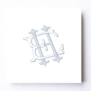 May include: A square white card featuring a light blue monogram of the letters E and H intertwined. The letters are designed with a decorative serif font, incorporating fleur-de-lis style accents at the top and bottom terminals of the characters.