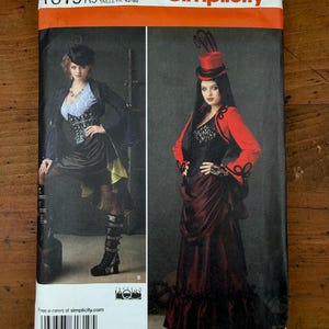 May include: Simplicity sewing pattern 1819 R5 featuring two costume designs. The left shows a black jacket, white lace top, black corset, and high-low skirt. The right shows a red jacket, black lace top, black corset, and long skirt with a top hat.