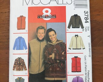 May include: A McCall's 3784 sewing pattern envelope for jackets and vests in sizes Small, Medium, and Large. The front features illustrations of eight different garment variations, including solid colors, patterns, and hooded designs, with a central photo of two people wearing a tan vest and a patterned hooded jacket.