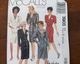 May include: A McCall's 3903 sewing pattern envelope for Fashion Basics featuring illustrations of five different blazer-style dresses. The white paper envelope displays models wearing various double-breasted designs in black, red, white, and plaid patterns.