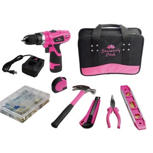 May include: A pink and black cordless drill, a black tool bag with the text "Seriously Pink", a hammer, a tape measure, a utility knife, pliers, a level, and a clear plastic container with assorted screws and other hardware.