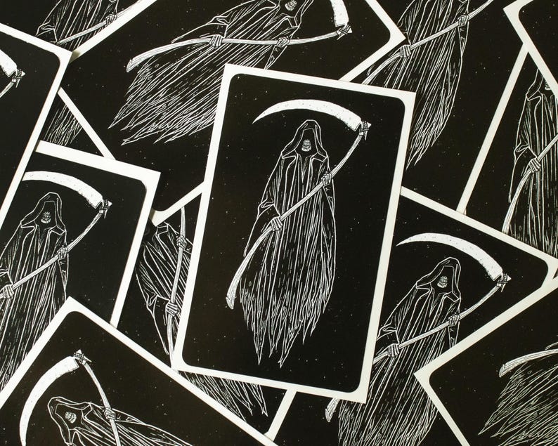 May include: A set of black and white tarot cards featuring a grim reaper with a scythe. The cards have a vintage, woodcut style.