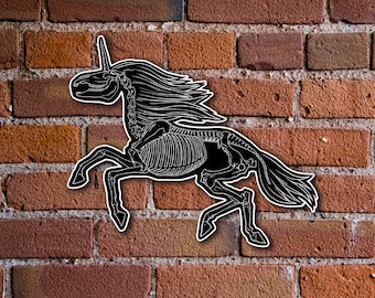 May include: A black and white illustration of a unicorn skeleton against a brick wall background.