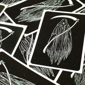 May include: A black and white illustration of the Grim Reaper holding a scythe. The image is on a white background with a black border.