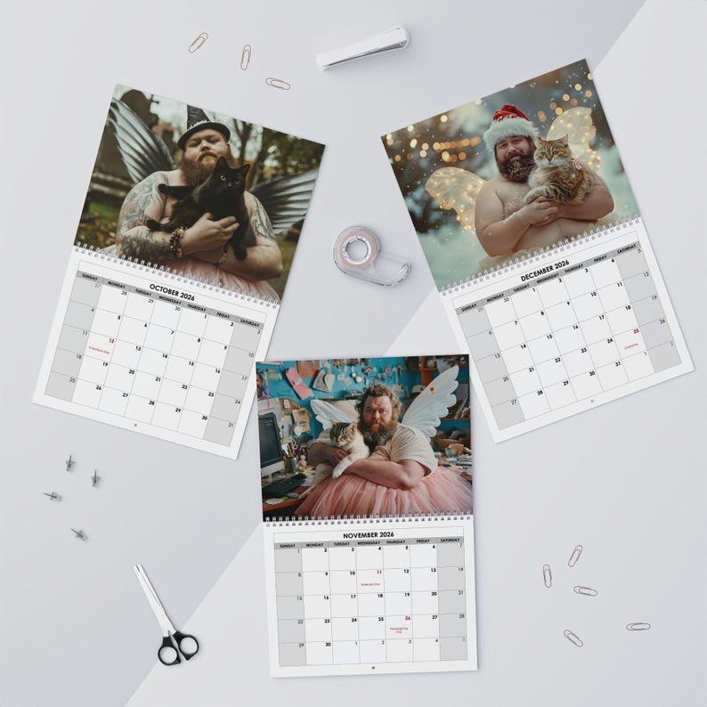 May include: A set of three 2024 calendars featuring a man with angel wings and a cat. The calendars are open to the months of October, November, and December. The man is wearing a tutu in each image.