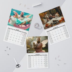 May include: Three wall calendars featuring humorous images of a man with cats. The July calendar shows the man in a flamingo floatie. The August calendar shows the man holding a cat. The September calendar shows the man with cats and pumpkins.