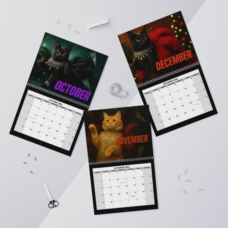 May include: Three wall calendars featuring cat illustrations for October, November, and December. The October page shows a black cat with purple text, November features an orange cat with red text, and December displays a black cat with red text.