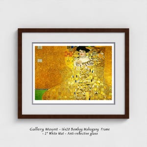 May include: Framed art print featuring a portrait of a woman in a gold dress, with a dark brown frame and white mat. The artwork has a gold background with geometric patterns. The frame is 16x20 inches.
