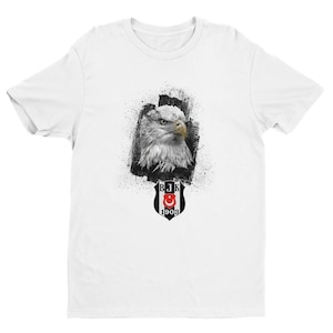 May include: White t-shirt with a black and white graphic of an eagle and a shield with the text "BJK 1903".