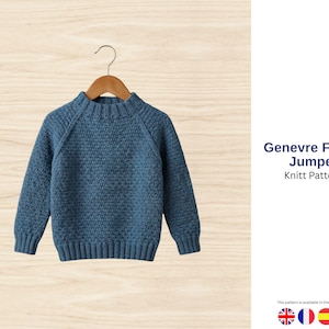 May include: A blue knitted jumper with a textured pattern hangs on a wooden hanger. The jumper has a crew neck and long sleeves. The text "Genevre Forest Jumper Knitt Pattern" is visible.