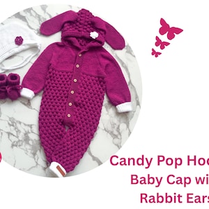 May include: A pink knitted baby romper with a hood and rabbit ears. The romper has white trim on the sleeves and a row of buttons down the front. A white knitted hat with a flower detail is also included.