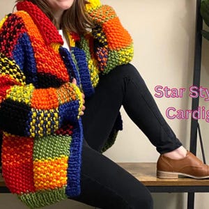 May include: A colourful, multi-coloured, chunky knit cardigan with a patchwork design. The cardigan is made of a thick yarn and has a loose fit. The text "Star Stylish Cardigan" is visible in the image.