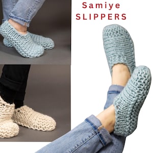 May include: A pair of knitted slippers in light blue and cream colours. The slippers are made with a chunky yarn and have a simple, cosy design. The text "Samiye SLIPPERS" is visible in the image.