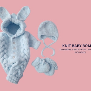 May include: A light blue knitted baby romper set with a hood and bunny ears, cable detail, a matching hat, and mittens. The set is designed for a 12-month-old baby. The set is made of a soft, textured material.