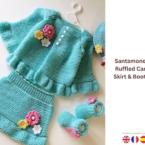 May include: A turquoise knitted baby set, comprising a cardigan, skirt, and booties, decorated with floral details. The set has a ruffled edge and is presented against a white backdrop. The image text reads "Santamone Floral Ruffled Cardigan, Skirt & Booties Set."
