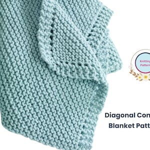 May include: A light blue knitted blanket with a diagonal stitch pattern. The blanket is folded in half and the edge is visible. The text "Diagonal Comfort Blanket Pattern" is visible in the image.