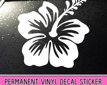 May include: A white hibiscus flower decal sticker featuring five rounded petals and a prominent stamen, applied to a dark, wet surface. The design is a solid, clean-cut graphic silhouette of a tropical flower, centered and clearly visible.