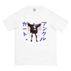 May include: White t-shirt with a wrestler holding an American flag and the text "カール" and "アント" in Japanese.