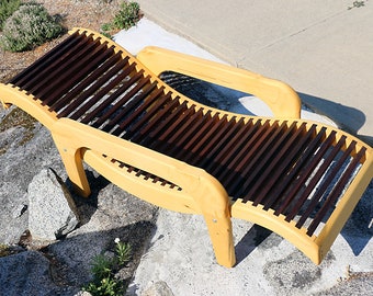 Lounging Chair of yellow and red cedar with horse head carvings