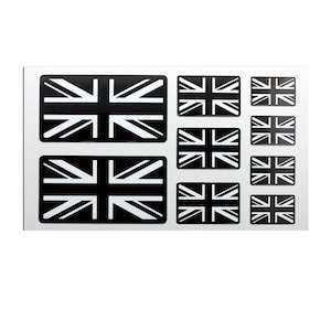 Könnte beinhalten: Eine Bogen mit schwarzen und weißen Union-Jack-Aufklebern in verschiedenen Größen. Die Aufkleber sind perfekt, um jeder Oberfläche einen Hauch von britischem Flair zu verleihen.