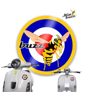 May include: A white scooter with a round headlight and a "buzz" logo featuring a cartoon wasp wearing a helmet. The logo is set against a blue, yellow, and red target design. The image also includes the text "Mia Buzz".