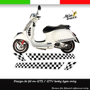 May include: White scooter with black seat and checkered accents. The scooter has red suspension and a black and white checkered pattern on the side. The image includes additional checkered decals and the text "Mia Buzz".