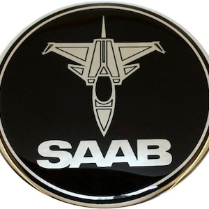 Emblema SAAB de avião a jato em cromo preto para capô, porta-malas, tampa traseira e volante. Adesivo 3D com relevo e verso autoadesivo. Vários tamanhos disponíveis.