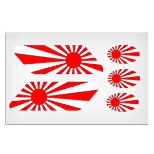 May include: A set of five red and white vinyl decals featuring a rising sun design. The decals are in two shapes: two rectangular and three oval.