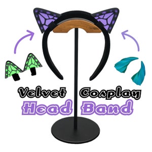 May include: Black velvet headband with purple butterfly ears. The headband is on a stand with two sets of additional butterfly ears in green and blue.