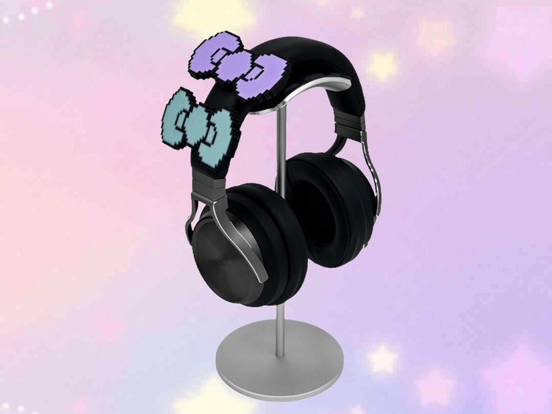 May include: Black headphones with a silver stand and two pixelated bow decorations in purple and blue.