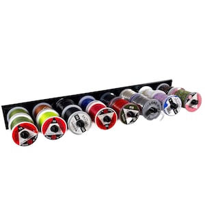May include: A black thread rack with 12 spools of thread in various colours, including green, red, black, blue, and purple. The rack has a label that says "LEAD WIRE".
