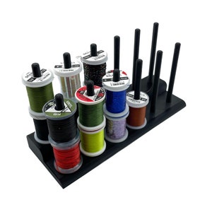 May include: A black thread rack with 10 spools of thread in various colors, including green, red, blue, and yellow. The spools are labeled with the thread type and size.