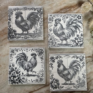 May include: Four square ceramic tiles with a black and white rooster design. Each tile features a detailed illustration of a rooster surrounded by floral patterns. The tiles are arranged together.