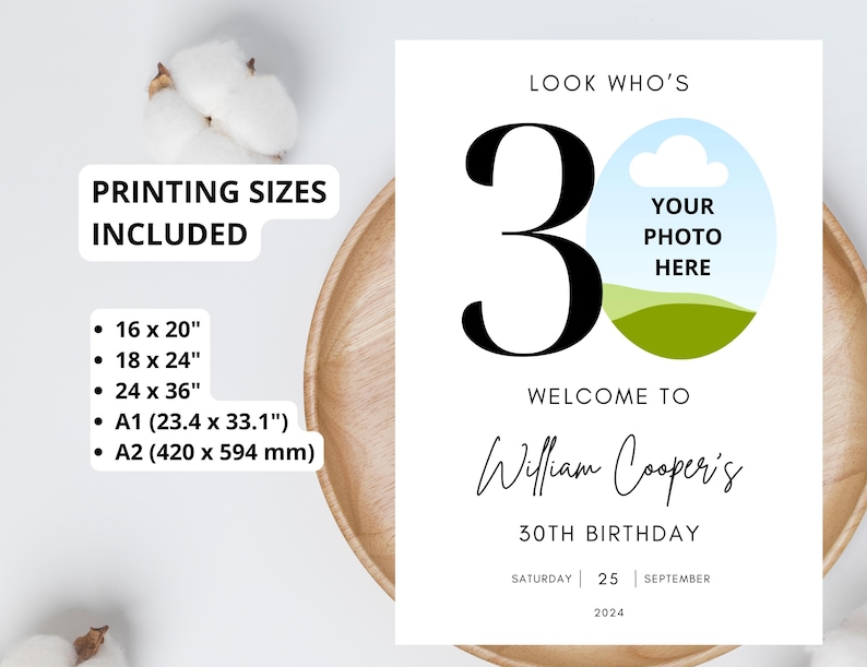May include: A white printable sign with a blue sky and green grass design. The number 30 is in black text. The text "Look Who's" is at the top of the sign. The text "Welcome to William Cooper's 30th Birthday" is in the middle of the sign. The text "Saturday 25 September 2024" is at the bottom of the sign. The sign has a place for a photo with the text "Your Photo Here".