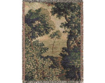 May include: Woven throw blanket featuring a pastoral landscape scene with trees and foliage in shades of green, brown, and beige. The edges are finished with a fringed border. The blanket's design evokes a vintage aesthetic.