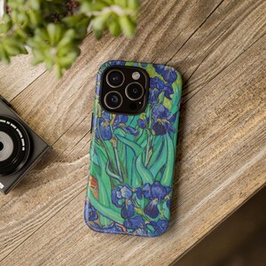 May include: A phone case with a vibrant blue and green floral design. The case features a close-up of a painting of irises, reminiscent of the style of Vincent van Gogh.