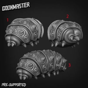 Op de afbeelding: Drie 3D-geprinte modellen van een gesegmenteerd, wormachtig wezen met een textuur. De modellen zijn genummerd 1, 2 en 3.