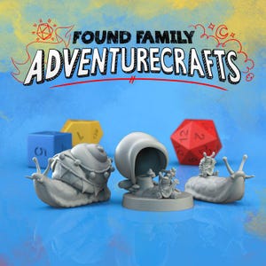 May include: Four miniature snail figurines with different designs, including a snail with a crown, a snail with a shell that looks like a house, a snail with a musician on its back, and a snail with a musician on its back. The snails are on a blue surface with a red and white dice and a yellow dice in the background. The text "FOUND FAMILY ADVENTURECRAFTS" is written in black marker on a yellow background.