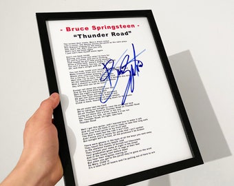 May include: Framed print of Bruce Springsteen's "Thunder Road" lyrics, featuring a blue signature. The black frame surrounds a white background with the song's title and lyrics. The Phonic Rapture logo is visible in the top right corner.